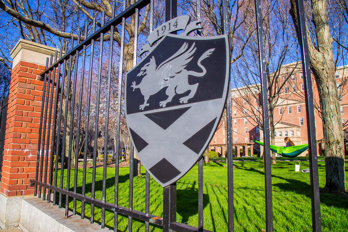 Exterior gate of Gaebe Commons with the JWU shield