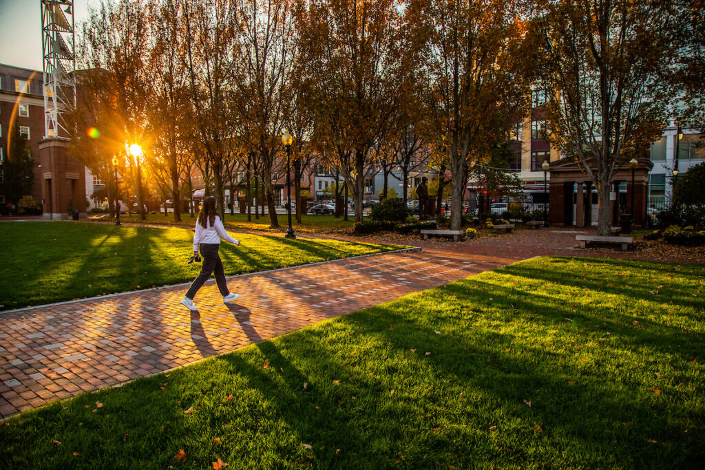 Gaebe Commons in the Fall with a student walking
