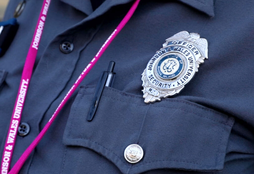 CLose up of a Johnson & Wales University safety and security badge