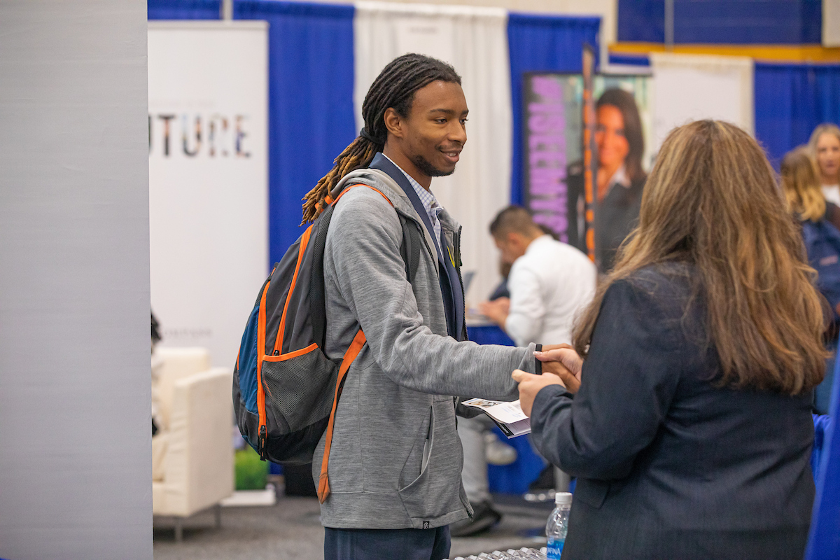 Student shaking hands with a potential employer