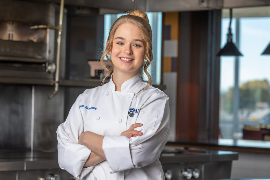 Charlotte student Chantelle Gonsalves poses in kitchen