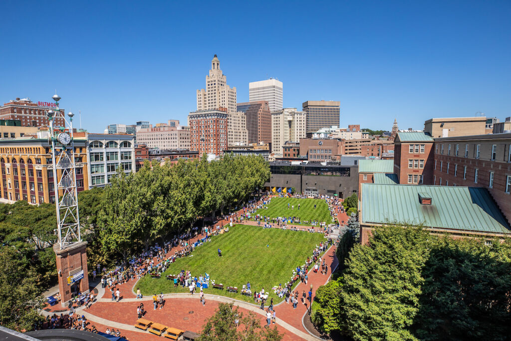 Overhead shot of students gathered on Gaebe Commons, with the Providence skyline in the background.