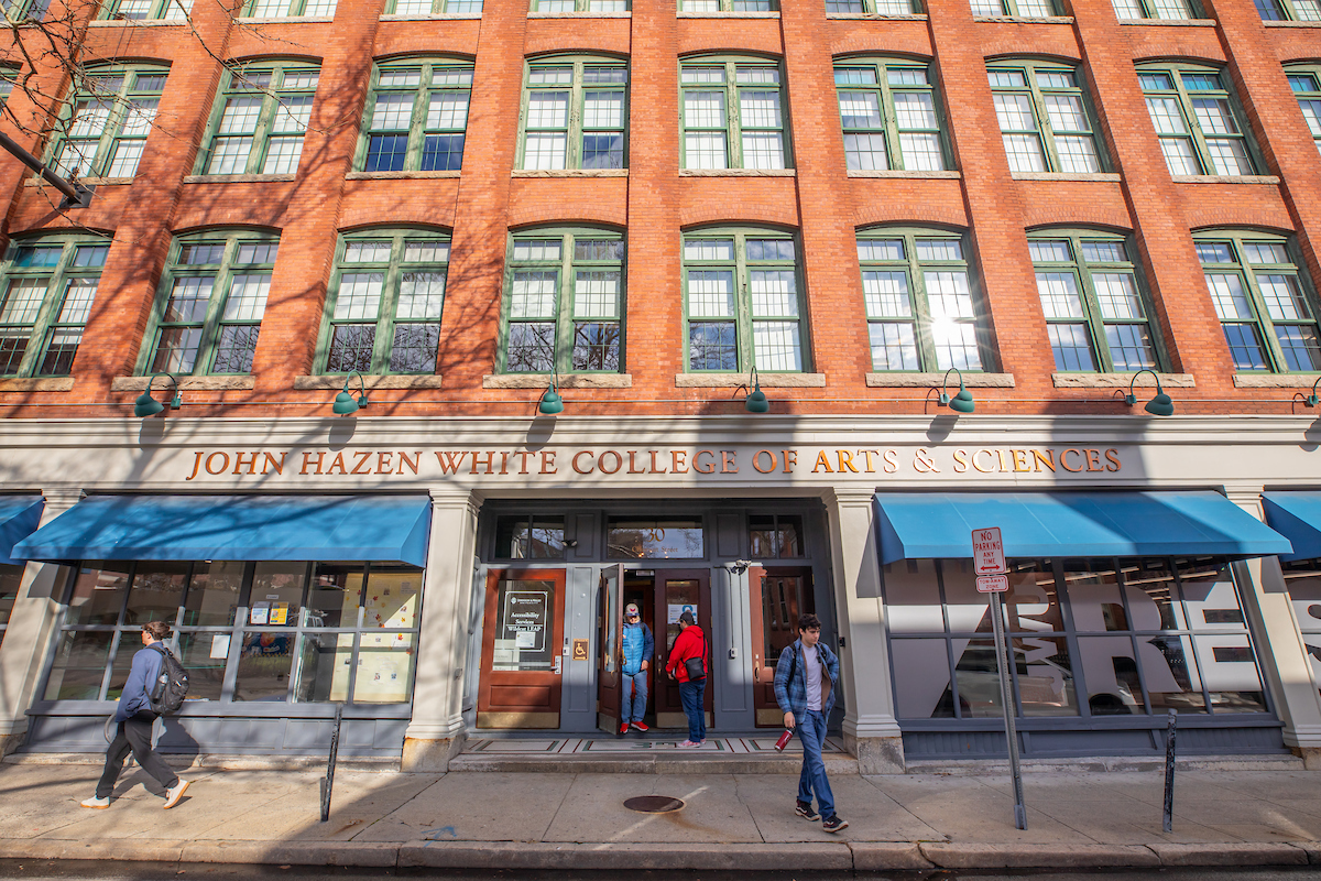 Students walk past the brick facade of John Hazen White College of Arts 