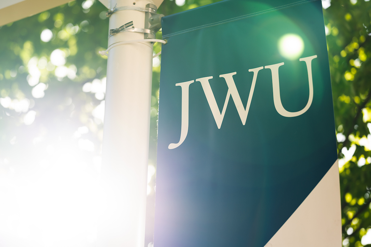 JWU banner on post with sunlight glowing
