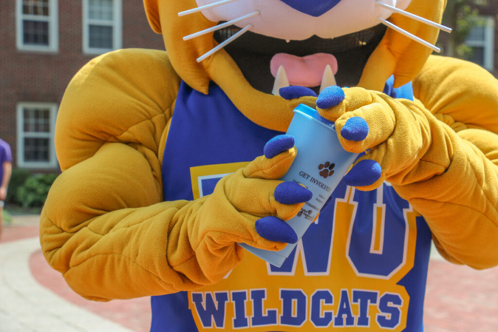 A yellow and blue mascot holding a blue cup with a paw print logo.