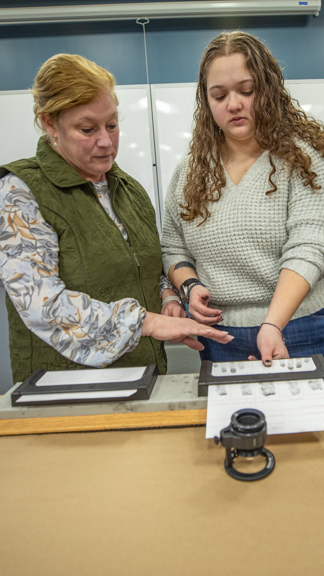 Two students practice finger printing in the crime lab