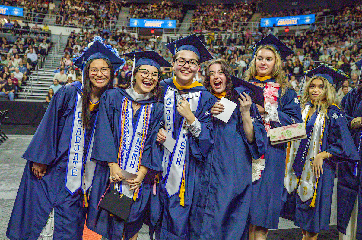 Students celebrate after receiving their diplomas