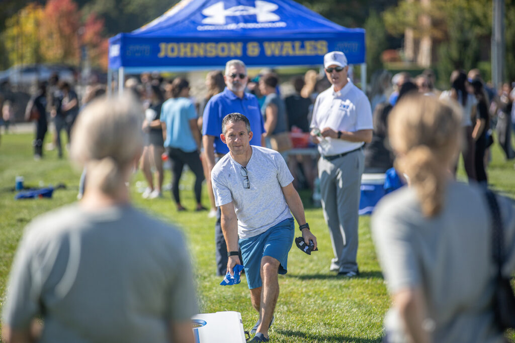 Parents play corn hole during homecoming weekend