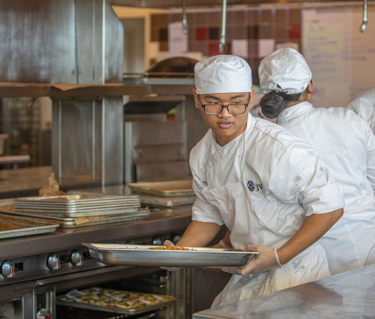 Male culinary student with tray
