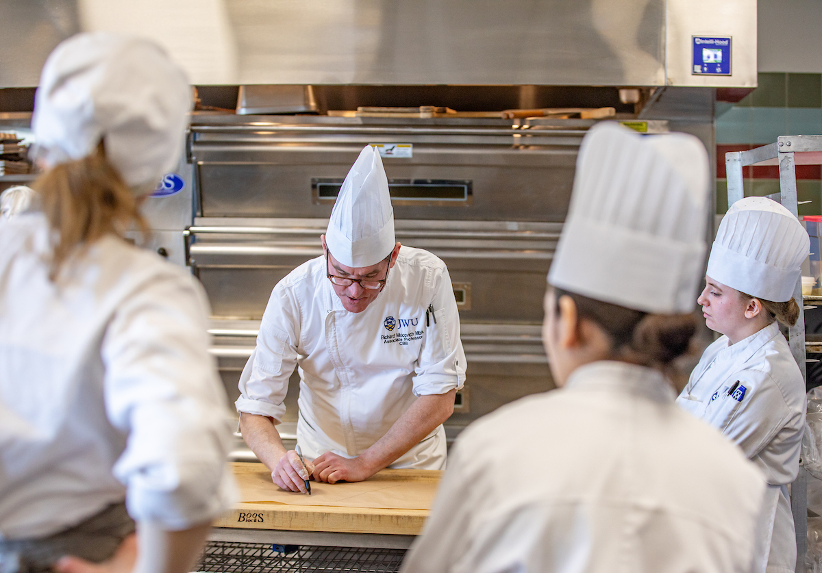 Chef demononstrating techniques during lab