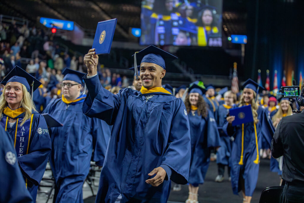 Student celebrates after receiving his diploma