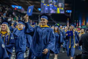 Student celebrates after receiving his diploma