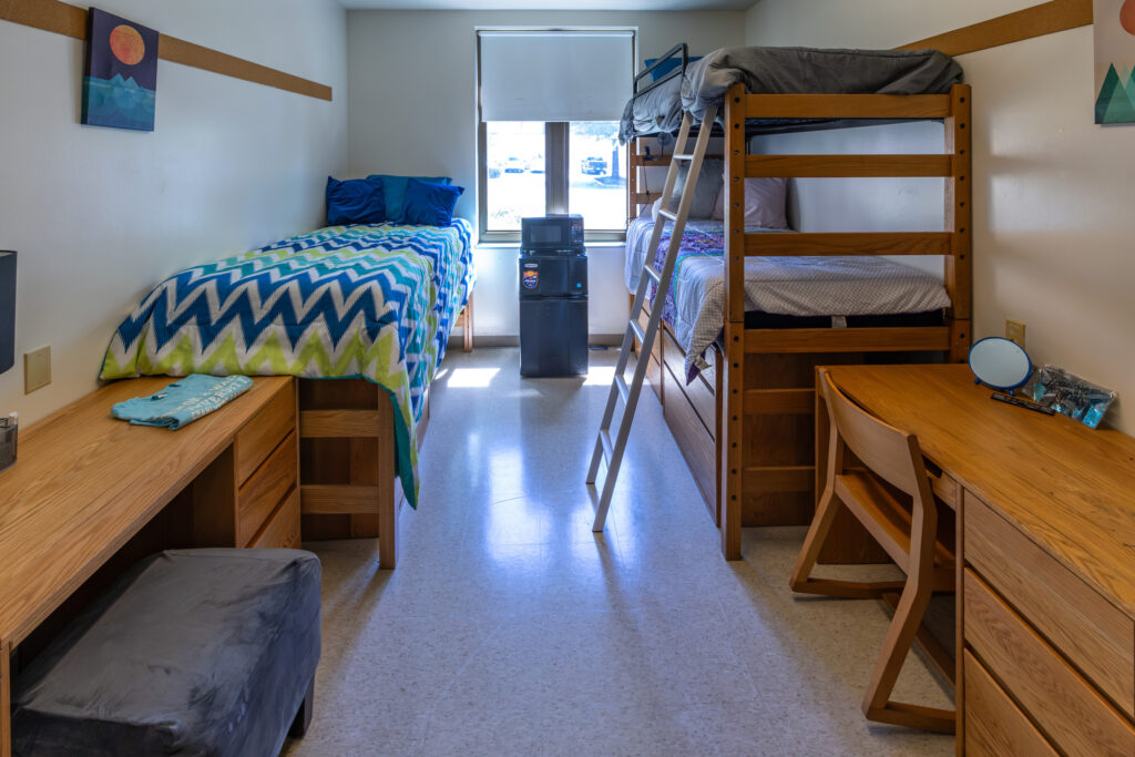 Bunk beds and furniture inside a residence hall room, JWU Charlotte