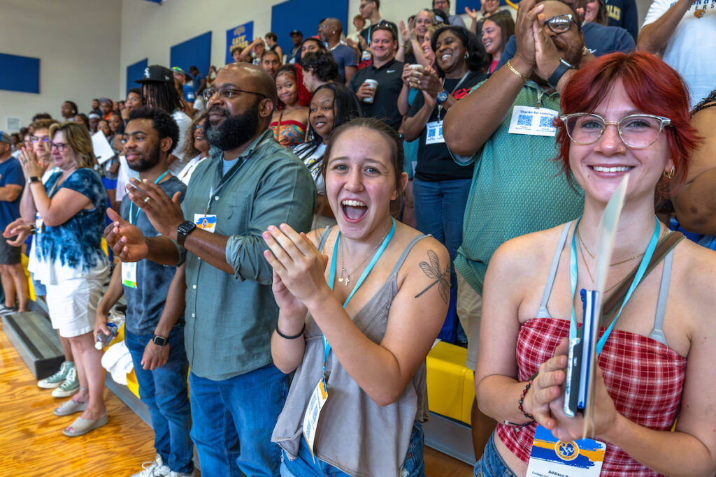Students and family members cheer during orientation in Charlotte.