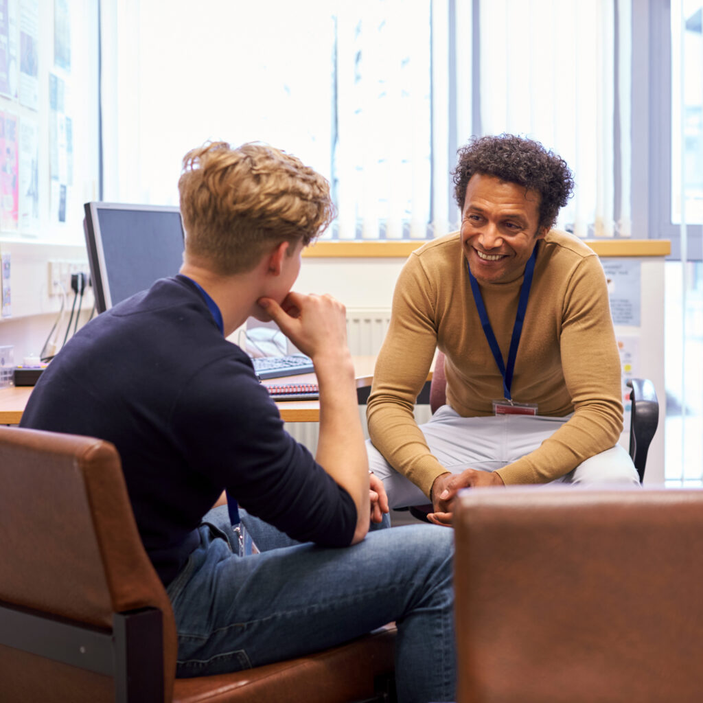 Two persons talking in a room.