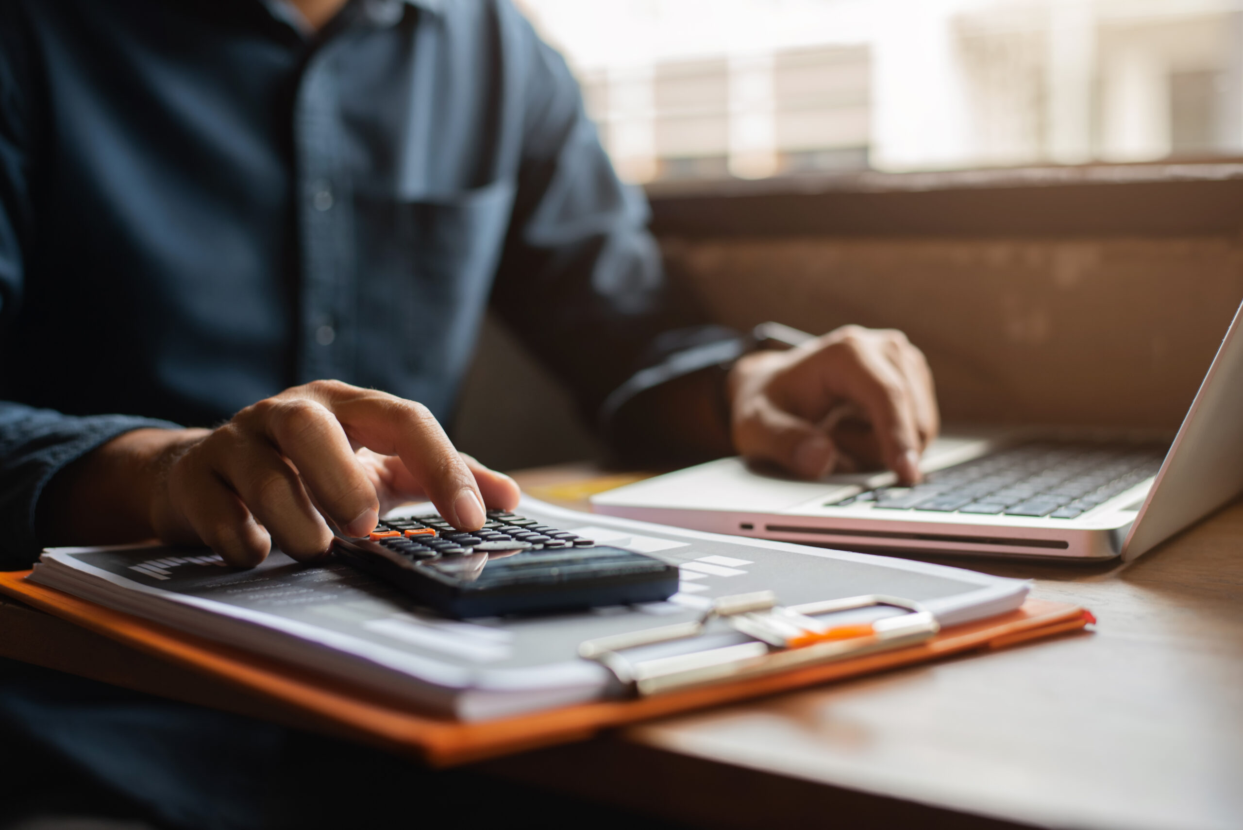 A person with a calculator and computer.