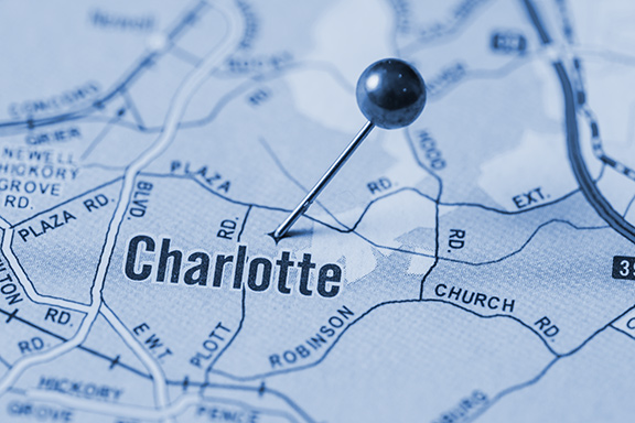 Close up of map of Charlotte with pin on it.