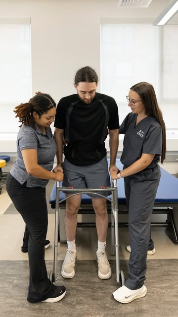 Doctorate of Physical Therapy students (DPT) practice helping a patient with a walker in the lab