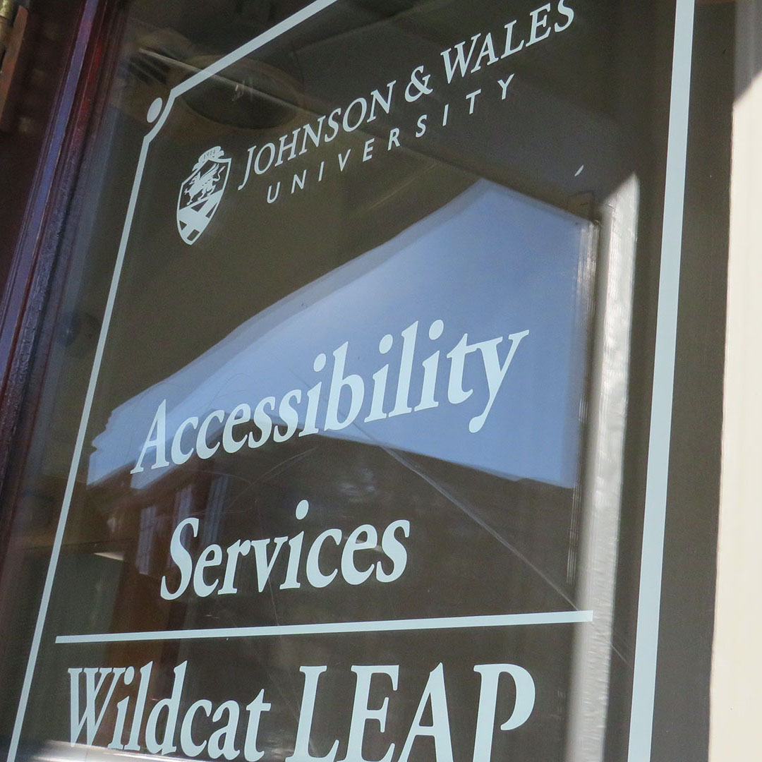 Doorway entrance to Leap Services, with a sign that reads Accessibility Services, Wildcat Leap.
