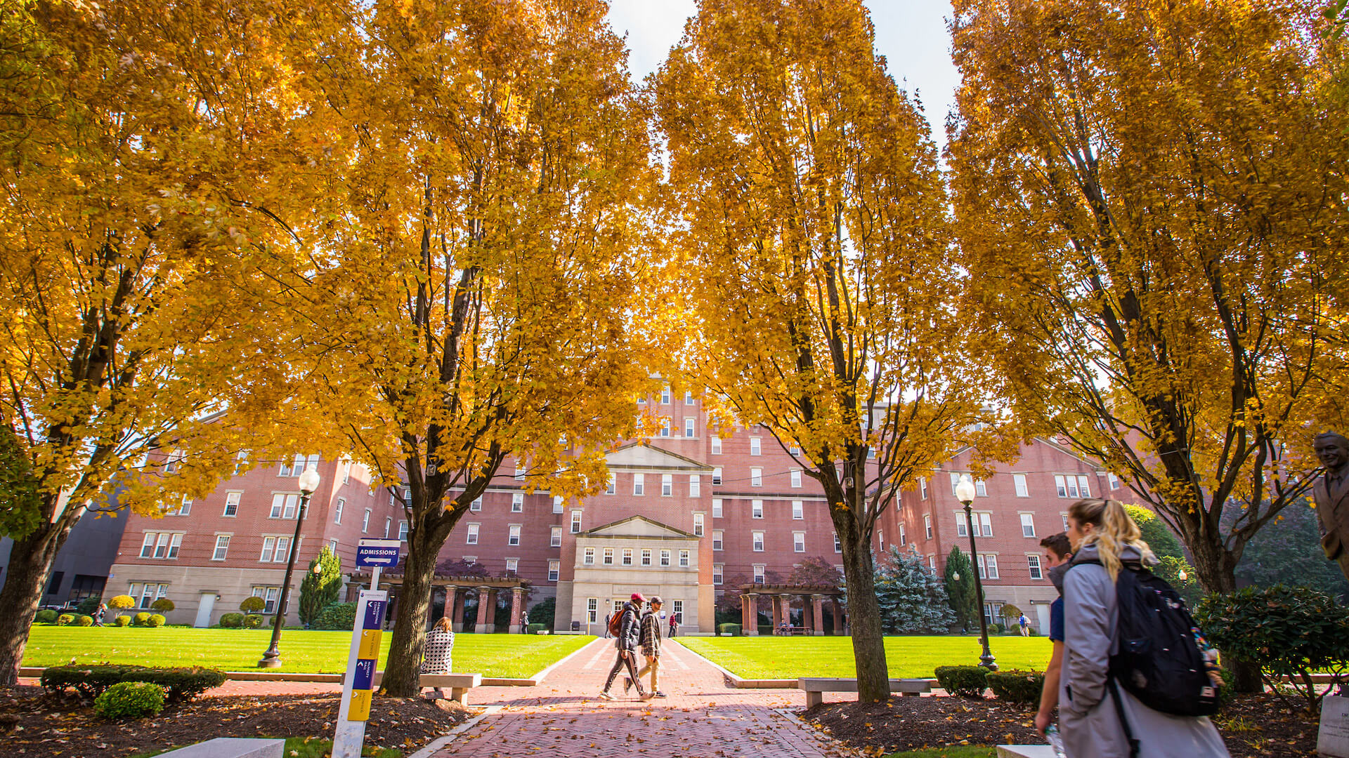 Student walking on Geabe Commons in Downcity