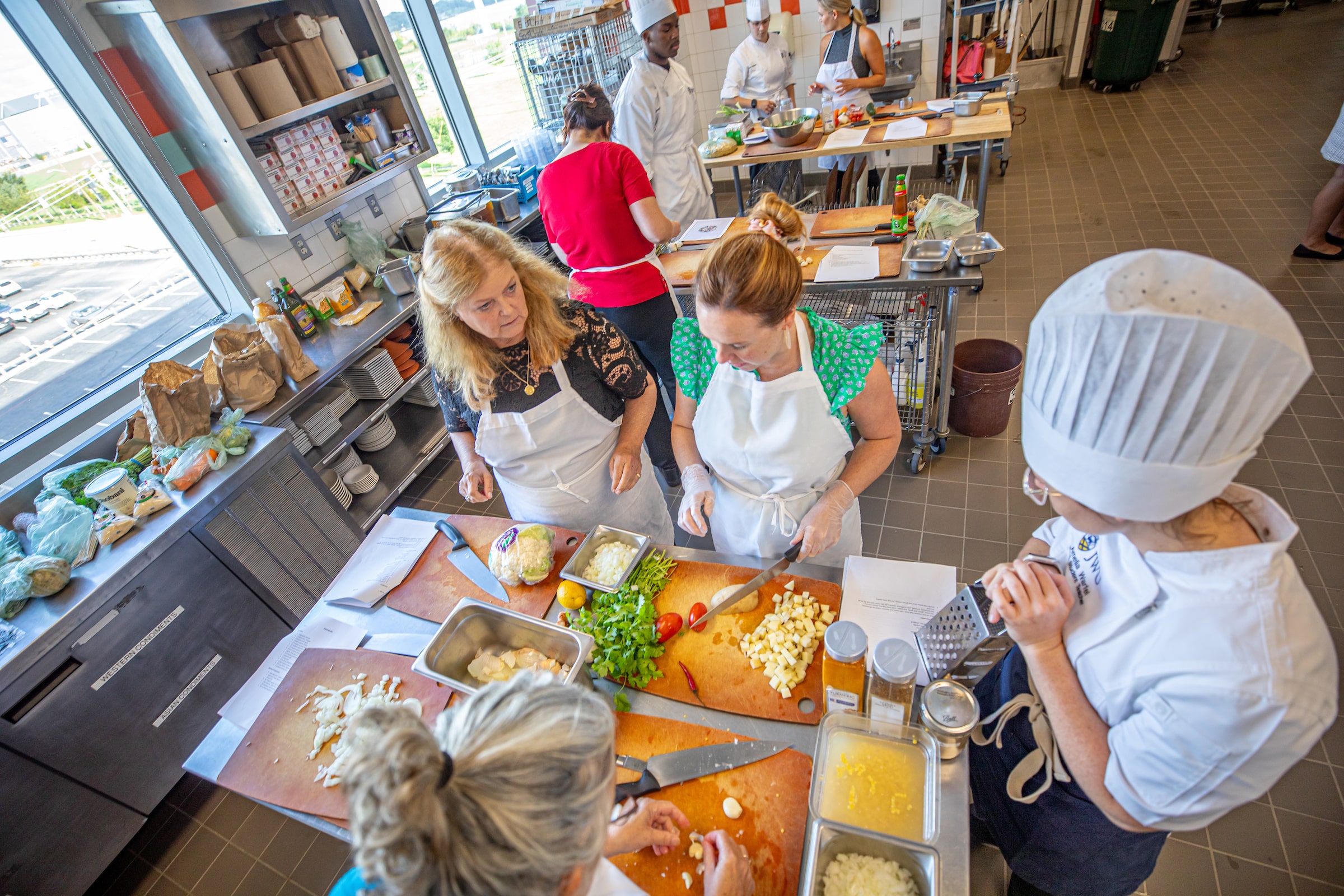 Group of recreational chefs making from-scratch food in the JWU Teaching Kitchen. 