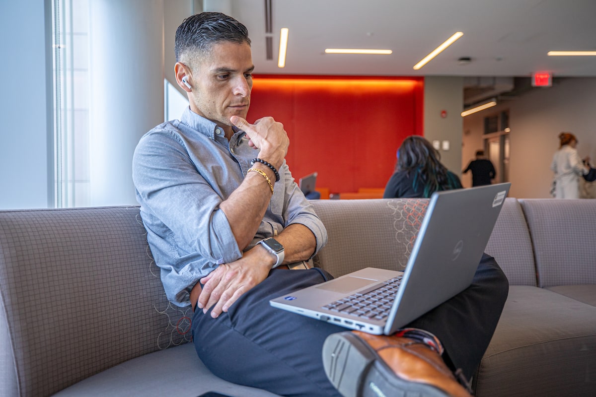 Male student studying in a quiet lounge space on campus.
