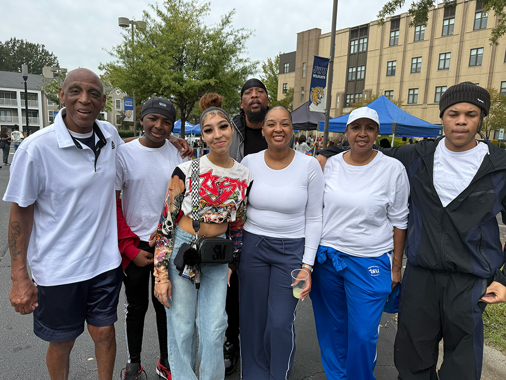 A family of seven people posing and smiling