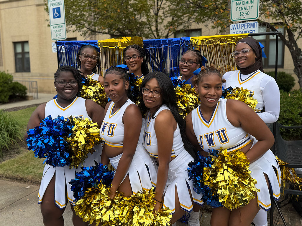 A group of JWU cheerleaders with pom poms