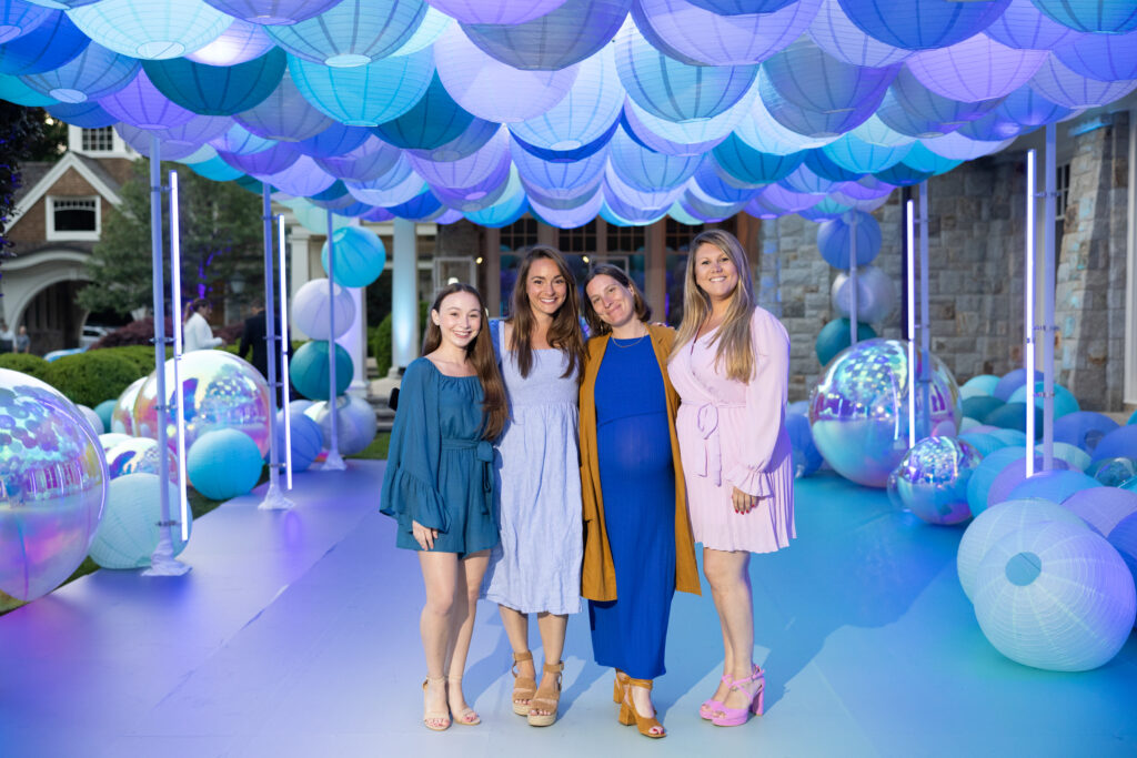 Alexandra Derosa smiling with a group of women.