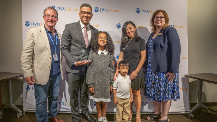 Arnaldo Almonte ’09 and his family pose for a picture with his award.