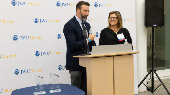 Karolina Guilcapi ’06 receives her award from Professor Bryan Lavin.