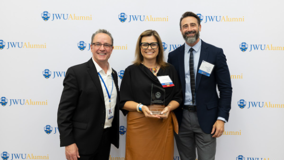 Karolina Guilcapi ’06 poses with President Greene and Professor Bryan Lavin.