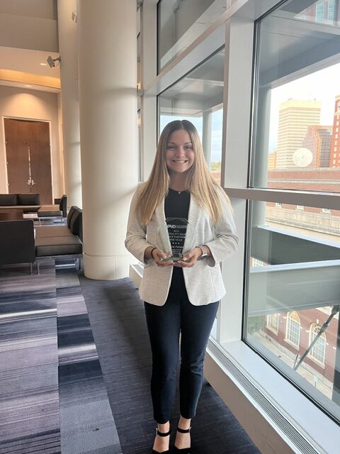 Victoria Patriarca smiling holding an award.