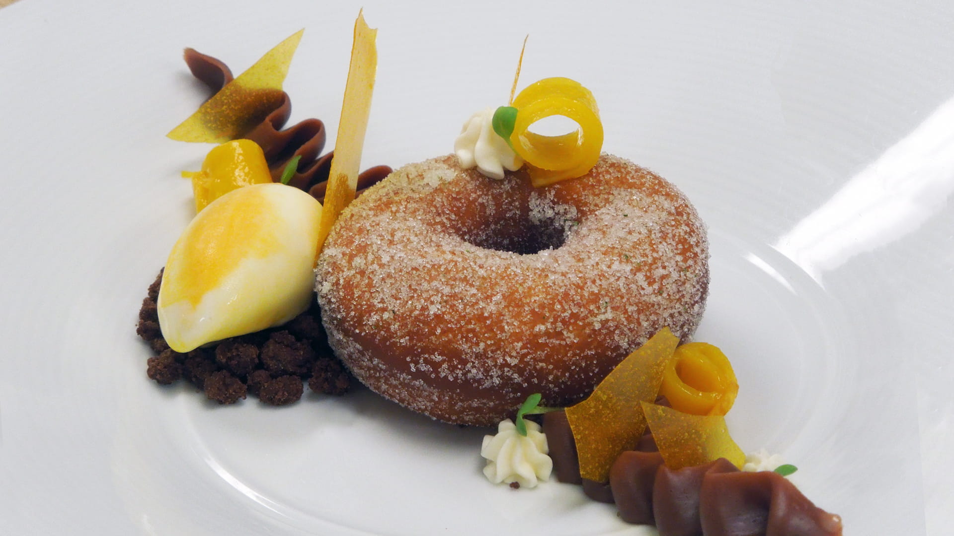 Jalapeu00f1o doughnut with milk chocolate cremeux, coconut ice cream, mango sorbet and mango ribbons