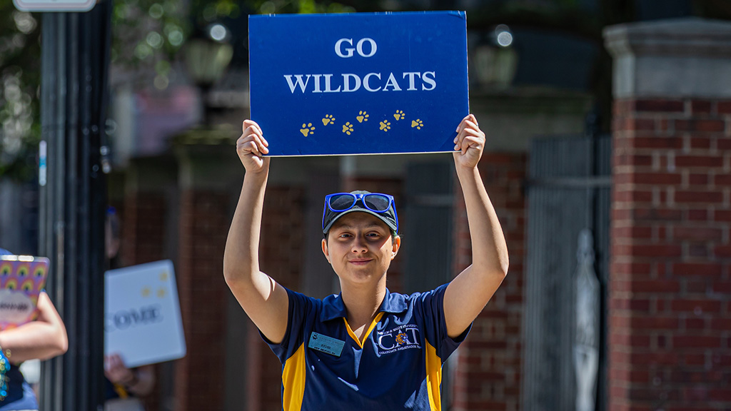 A student holding up a sign that reads 