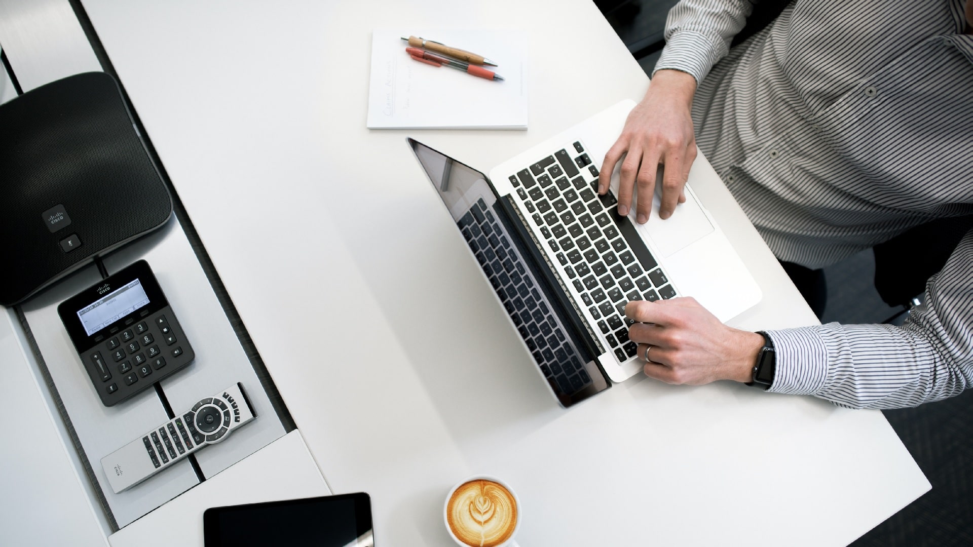 a man typing on his computer