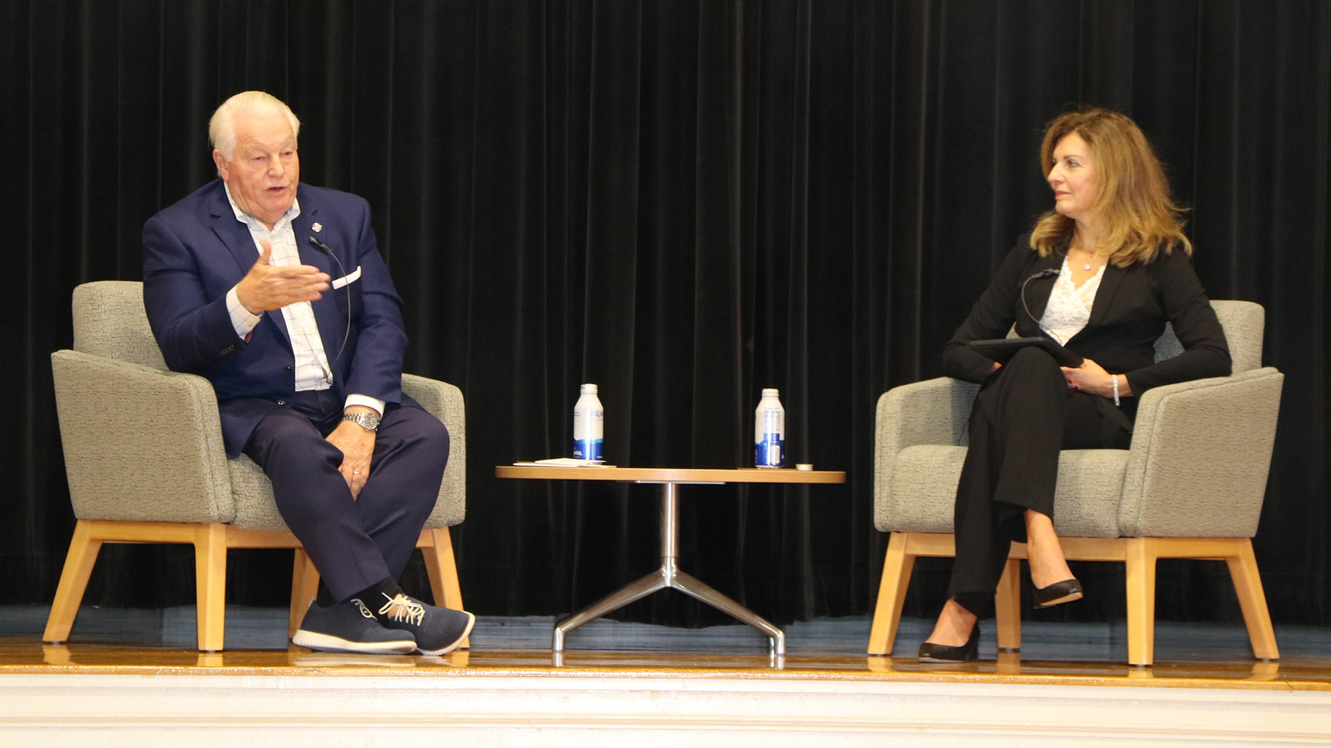 Roger Dow u201909 Hon. and JWU Providence Campus President Marie Bernardo-Sousa LP.D. u201992 on stage at the Hospitality Summit.