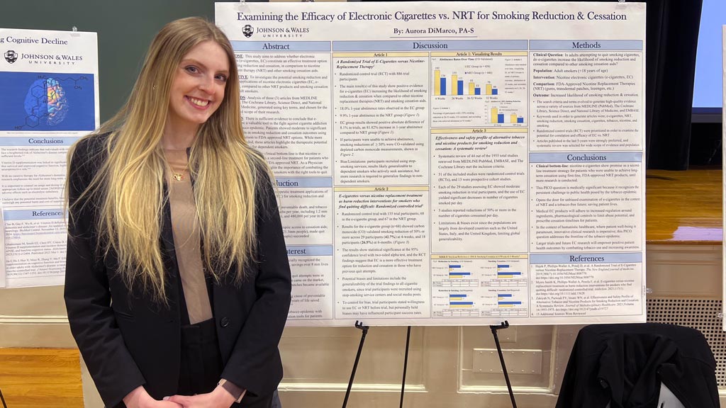 PA student Aurora DiMarco poses next to the poster for her master's research project