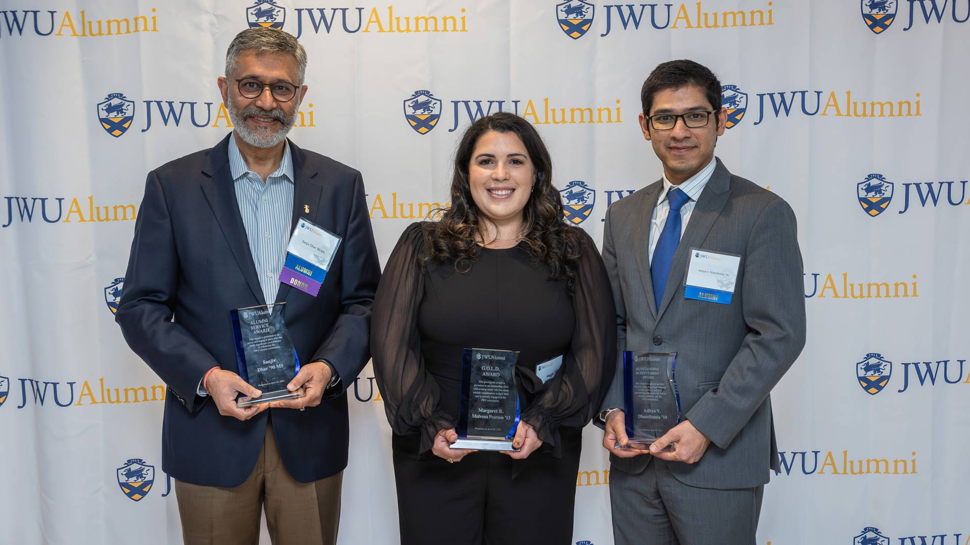 group photo of Alumni Service Award Winner Sanjiv Dhar u201990 M.S., Graduate of the Last Decade (G.O.L.D.) Award Winner Margaret R. Mulvena Pearson u201913 and Outstanding Achievement Award Winner Aditya V. Dhandhania '10 holding their awards