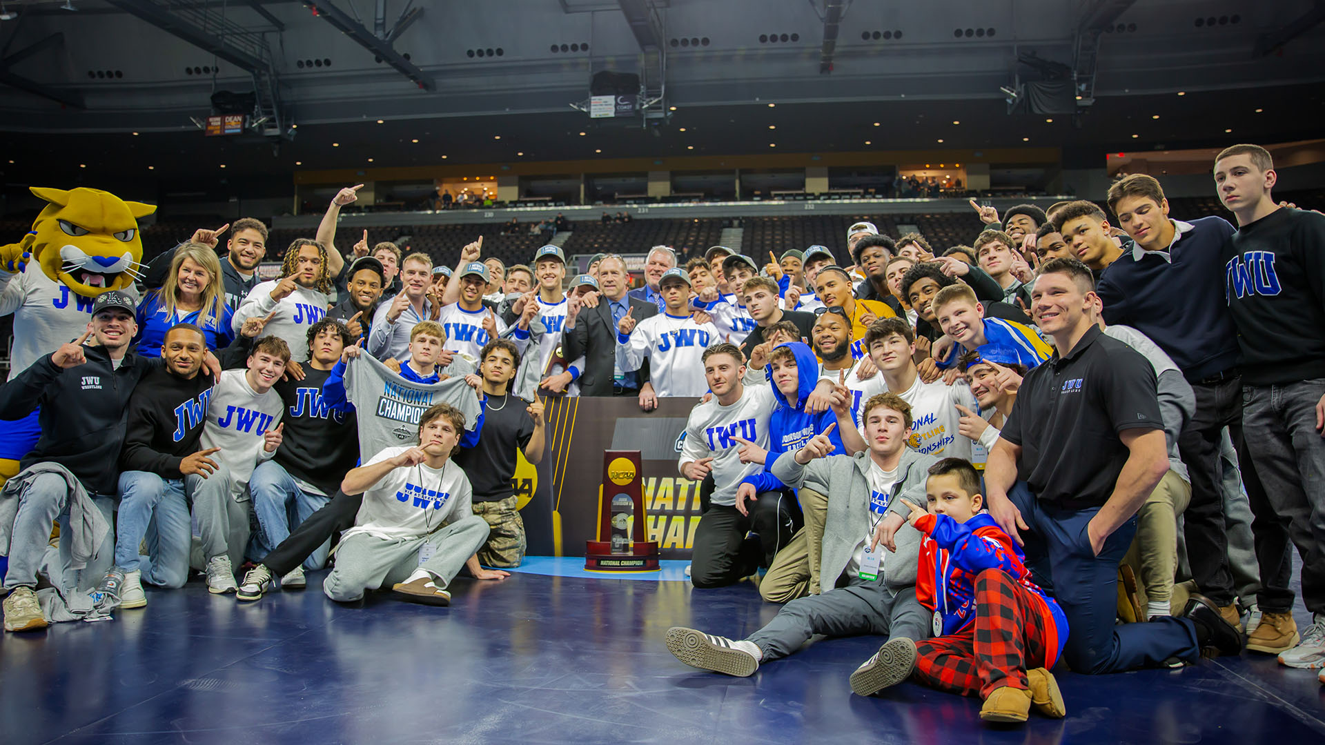 JWU Wrestling poses with championship trophy
