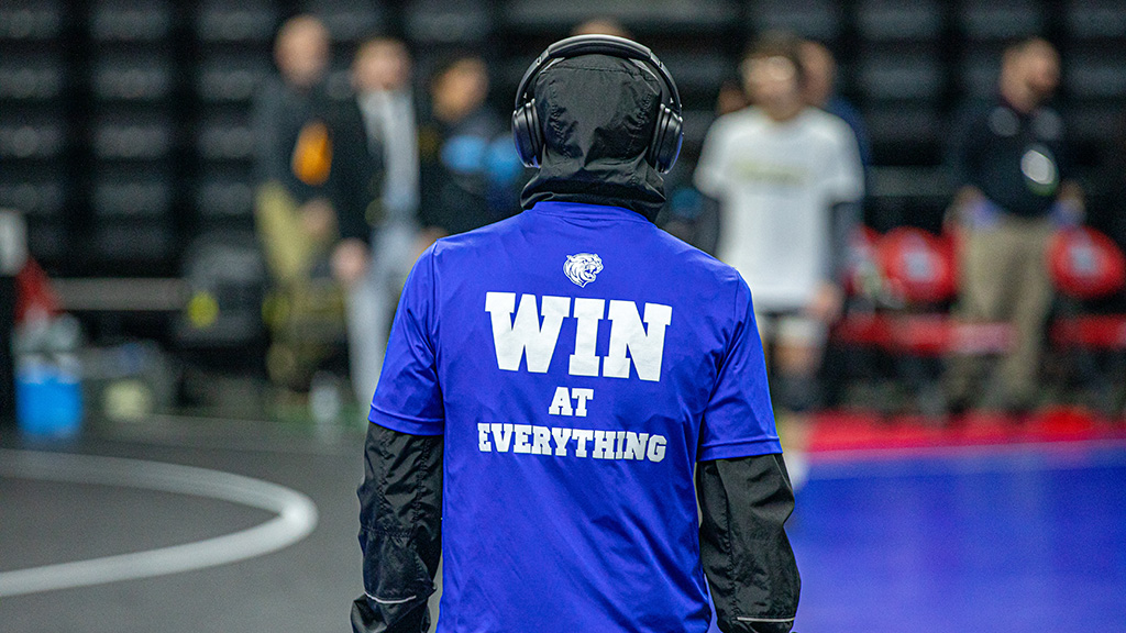 Wrestler wearing a shirt that says win at everything