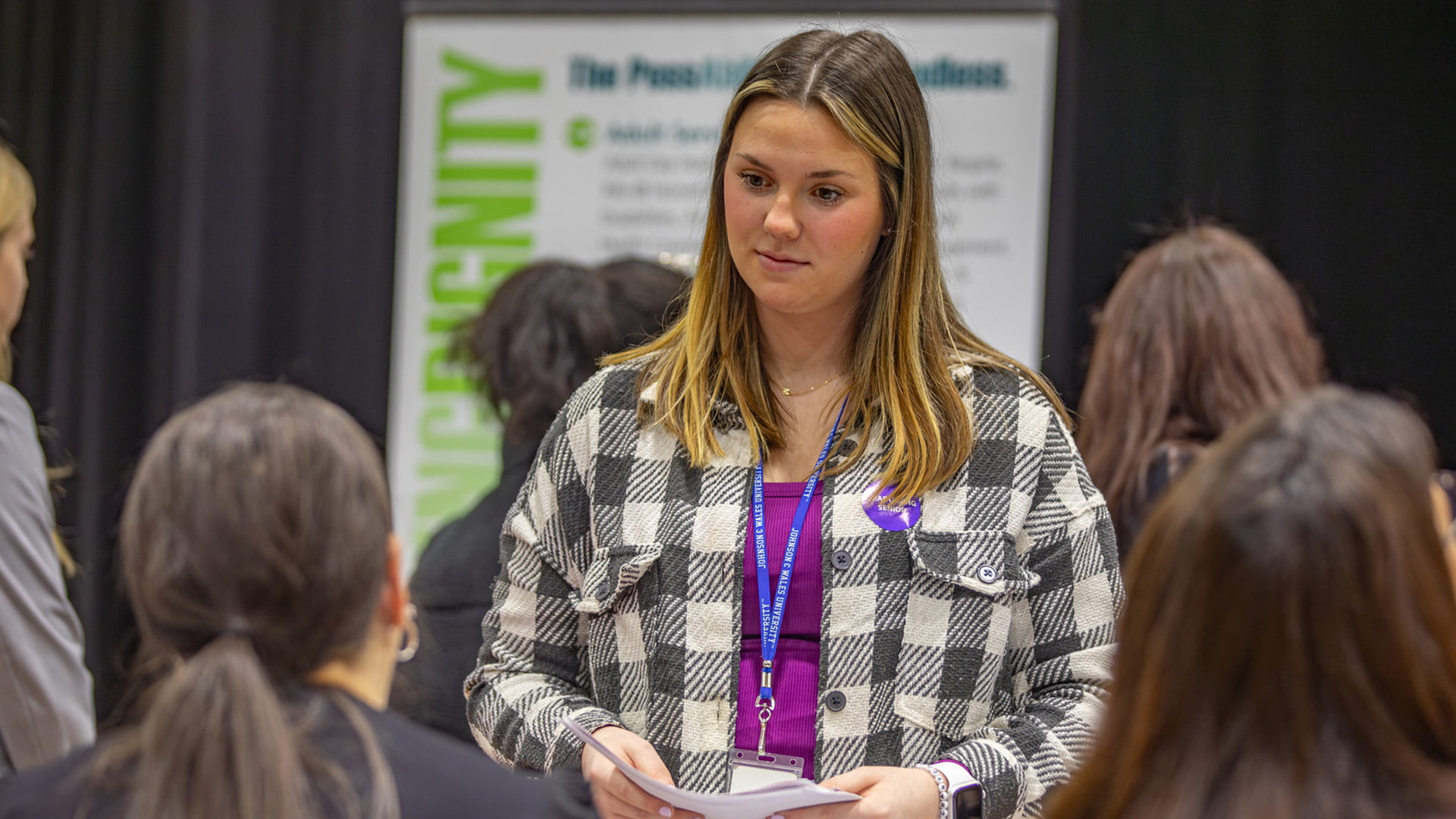 student talking to employers at behavioral health, and sciences career fair