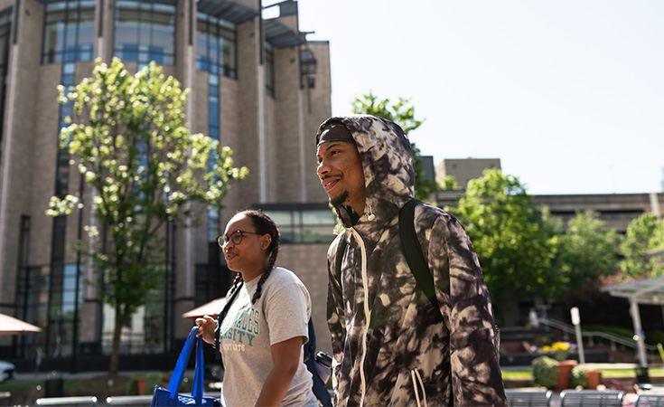 Two students walking across the JWU Charlotte campus.