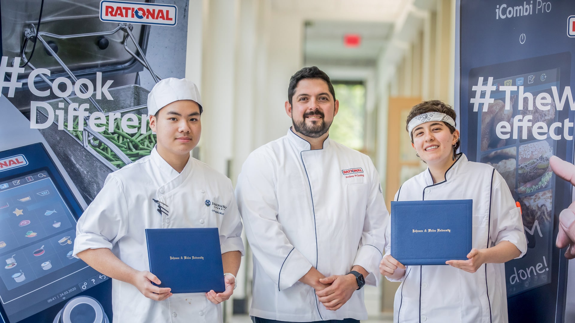a photo of Chef Andres Prussing of RATIONALE between the two Future Food Scholarship Program winners