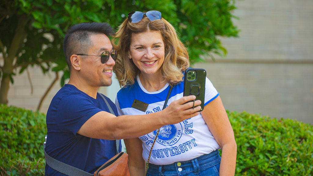 Marie Bernardo-Sousa taking a selfie with a student