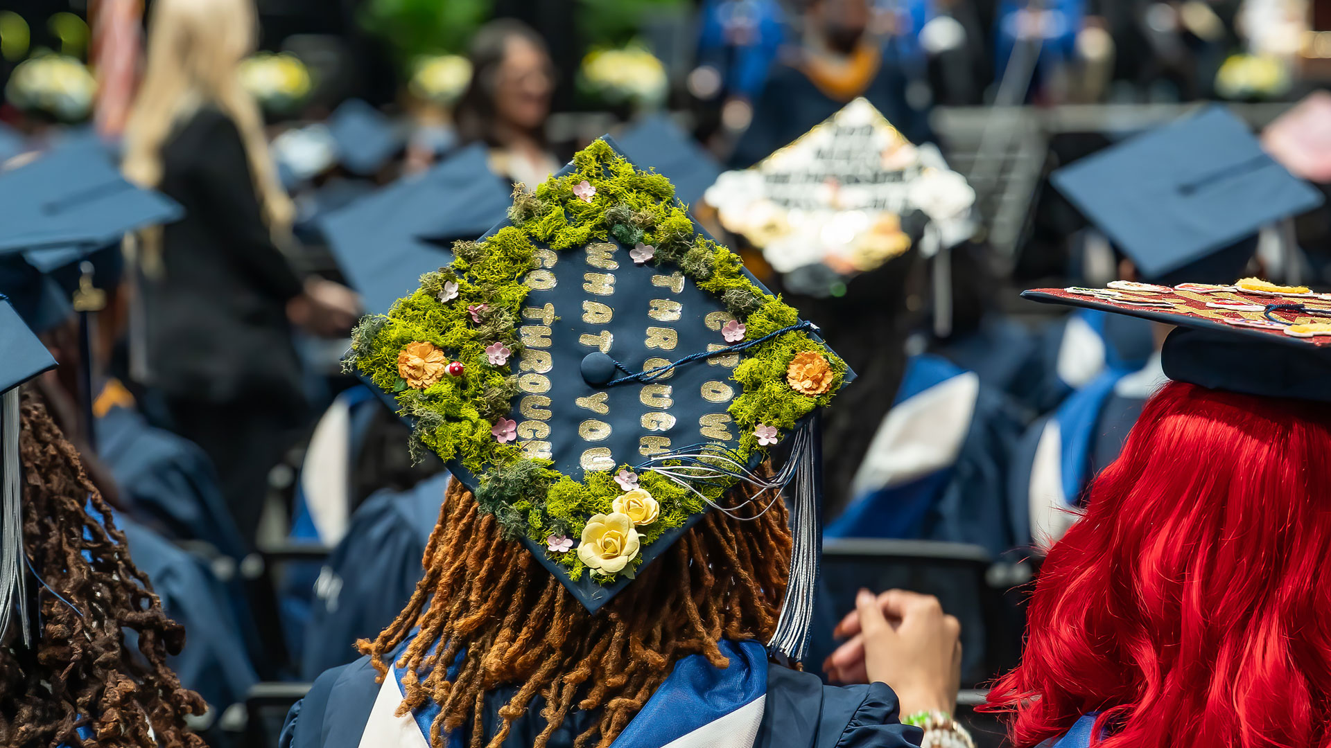 Closeup of a decorated mortarboard reading, u201cGrow through what you go through.u201d