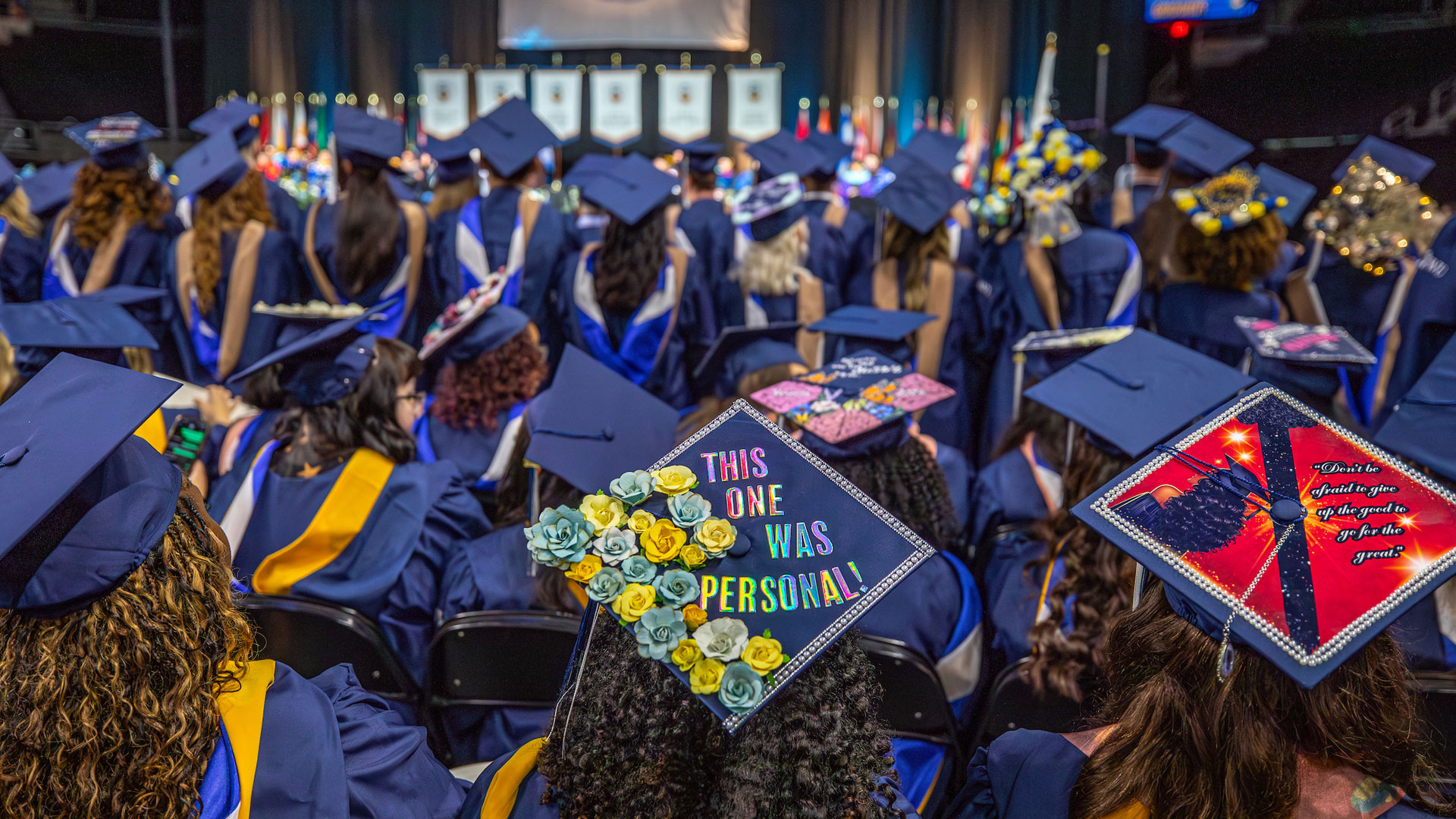 Sea of decorated mortarboards, including one eblazoned with u201cThis one was personal.u201d