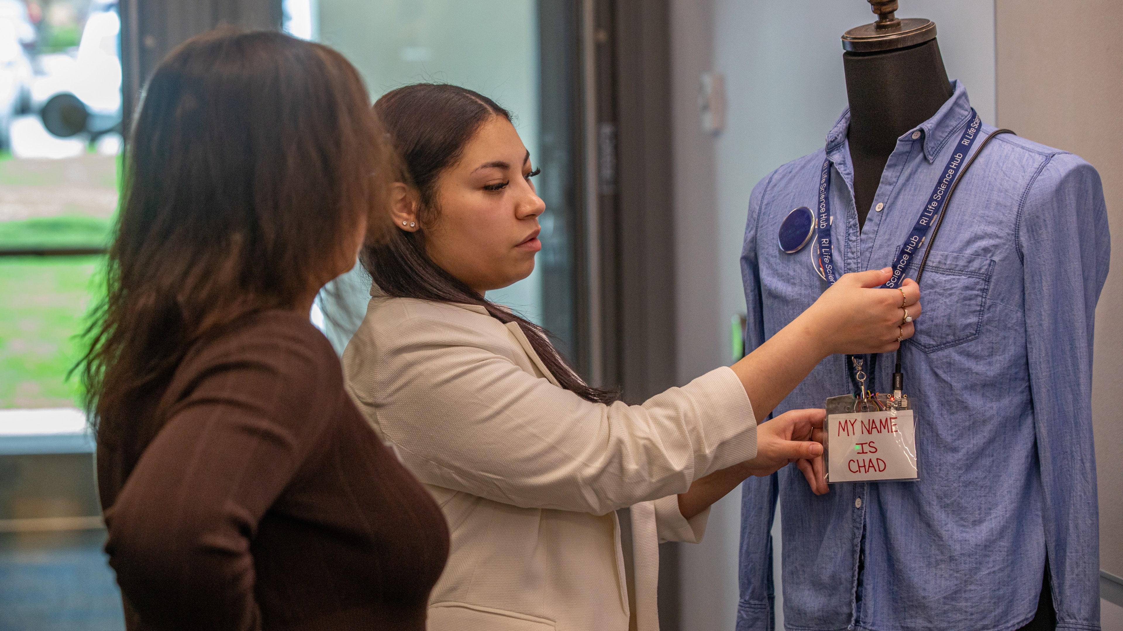 Valerie Rosario ’25 shows attendees how her AAC device could help people with communication challenges.
