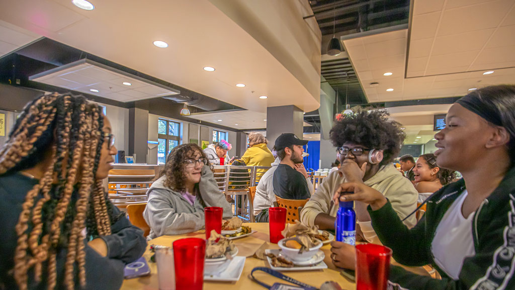 Charlotte students catch up over lunch in the dining hall.
