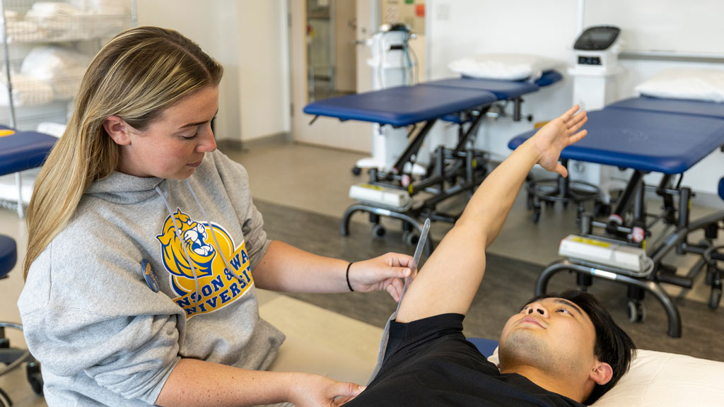 Assistant Professor Emily Berthelette demonstrating techniques to students